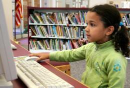 girl on computer in library